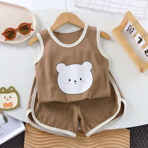 Children's brown sleeveless top and shorts set with bear design on a white surface.
