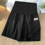 Load image into Gallery viewer, Black skort with a brand label on a textured surface
