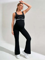 Load image into Gallery viewer, Woman wearing a black athletic outfit with white text on a light gray background
