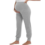 Load image into Gallery viewer, Gray sweatpants worn by a person on a white background
