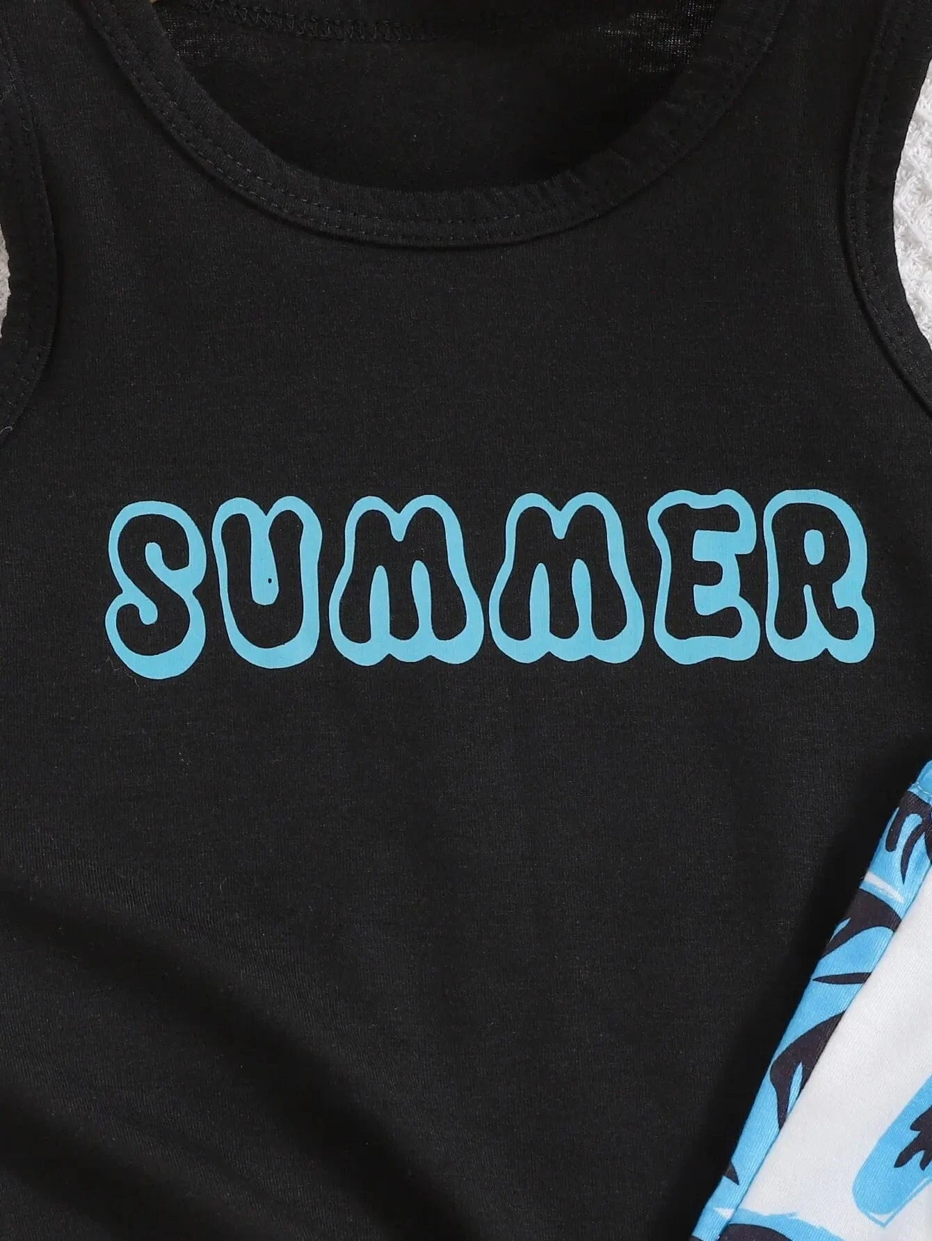 Black tank top with 'SUMMER' text in blue on a close-up view
