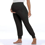 Load image into Gallery viewer, Black jogger pants worn by a person on a white background

