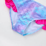 Load image into Gallery viewer, Mermaid scale patterned swimsuit with pink trim on a light background
