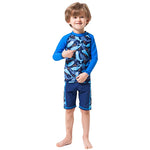 Load image into Gallery viewer, Child wearing a blue and gray shark-patterned swimsuit on a white background
