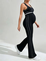 Load image into Gallery viewer, Person wearing a black outfit with white stripes on a light gray background
