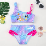 Load image into Gallery viewer, Children's swimsuit set with mermaid scale design and cartoon characters on a white background.
